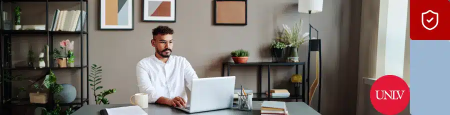 the computer is open in front of him showing him The Future of Tech in Las Vegas Aligning Your Skills with Emerging Trends